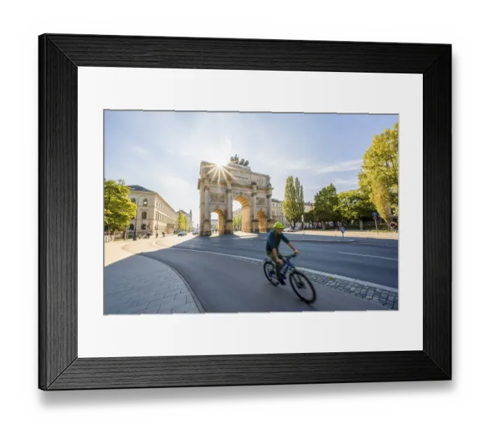 Framed Print : Sun star, Siegestor, cyclist riding along Leopoldstrasse Framed Print : Sun star, Siegestor, cyclist riding along Leopoldstrasse