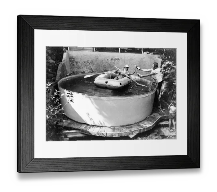 Framed Print : Man with lifejacket in inflatable dinghy in paddling pool