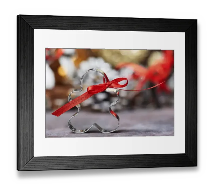 Framed Print : Cookie Cutter with Red Bow in Front of Christmas Decoration Framed Print : Cookie Cutter with Red Bow in Front of Christmas Decoration