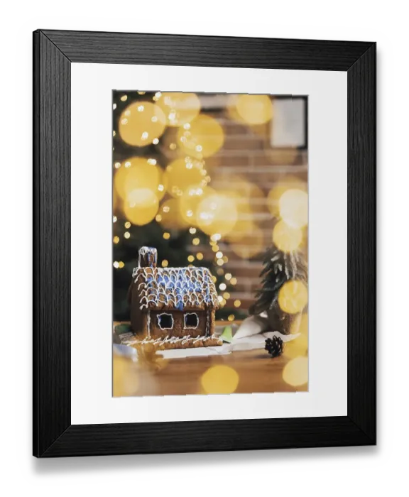 Framed Print : Little homemade gingerbread house with glaze standing on the table with decorations