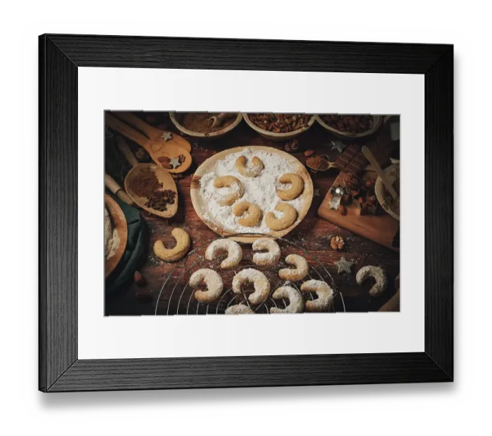 Framed Print : Baked vanilla crescents on a cake rack and in icing sugar Framed Print : Baked vanilla crescents on a cake rack and in icing sugar