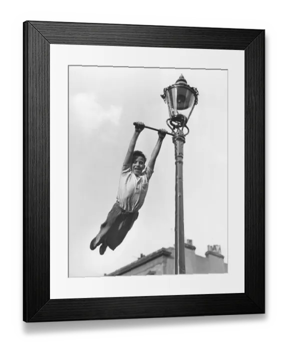 Framed Print : Boy swings to Lantern, England, Great Britain Framed Print : Boy swings to Lantern, England, Great Britain