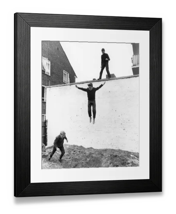 Framed Print : Boy leaps from wall, England, Great Britain Framed Print : Boy leaps from wall, England, Great Britain