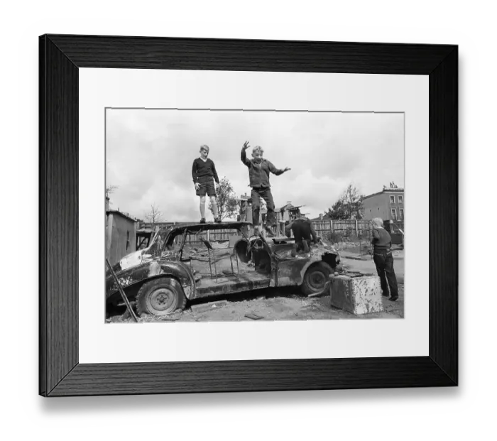 Framed Print : Three children play with car wreckage Framed Print : Three children play with car wreckage