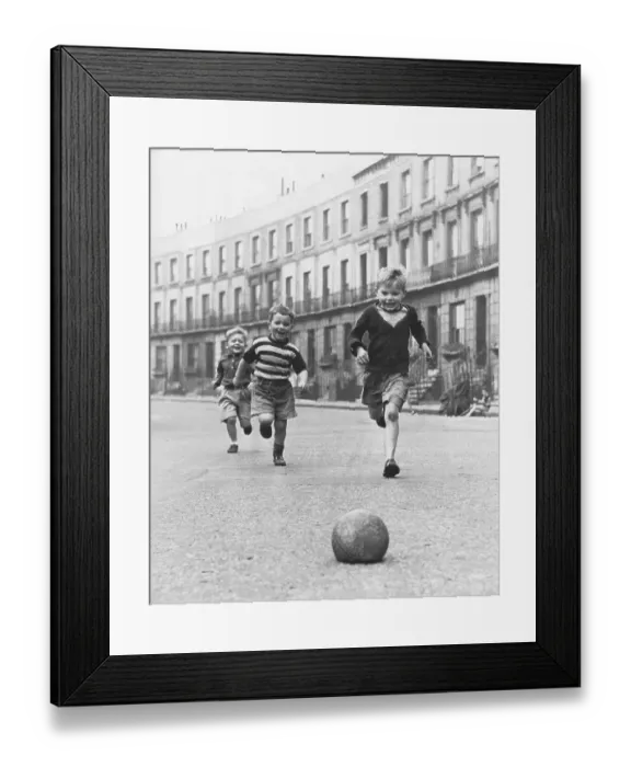 Framed Print : Children play football on the street Framed Print : Children play football on the street