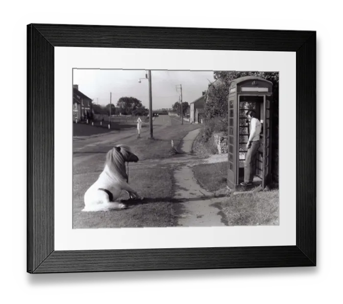 Framed Print : Man on the phone in a payphone box