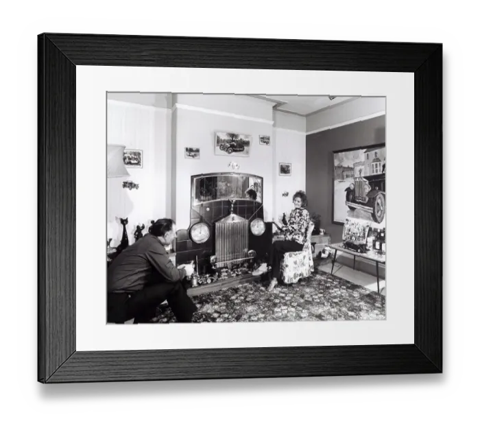 Framed Print : Married couple sitting in apartment with car decoration