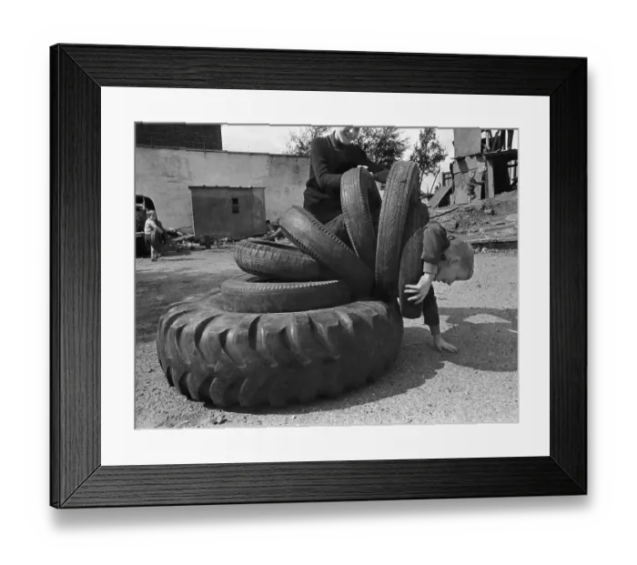 Framed Print : Child playing with tyres, England, Great Britain