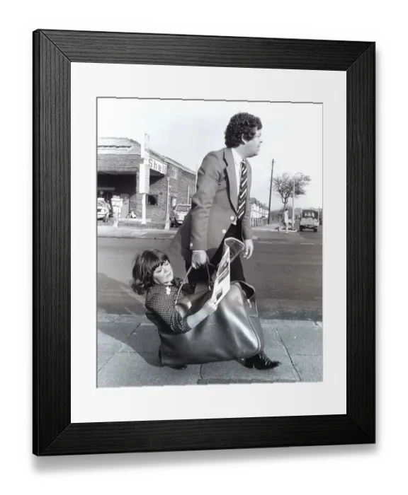 Framed Print : Man carries woman in bag, England, Great Britain Framed Print : Man carries woman in bag, England, Great Britain
