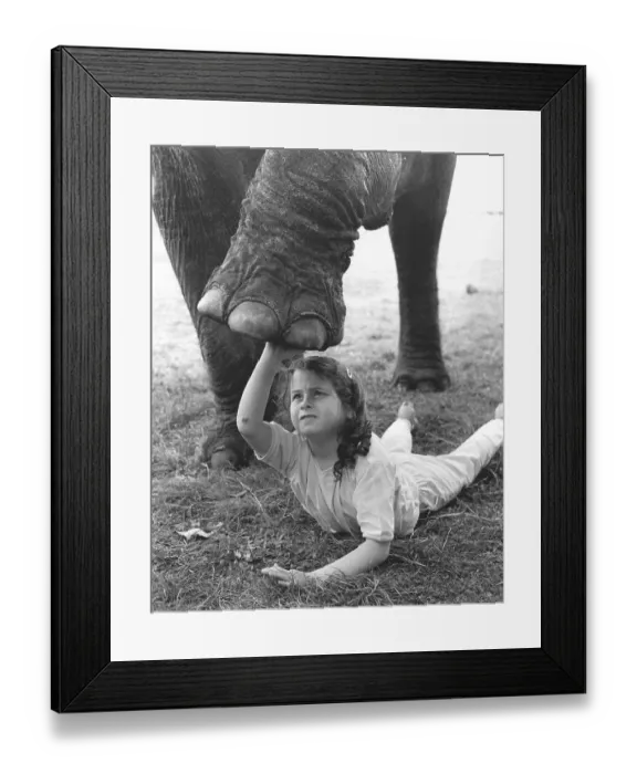 Framed Print : Girl with elephant leg, England, Great Britain