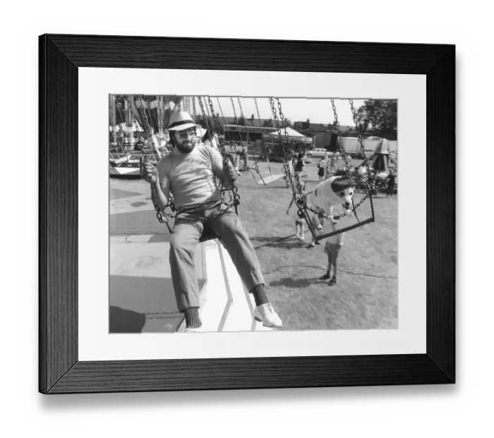 Framed Print : Man and Jack Russell Terrier driving a carousel