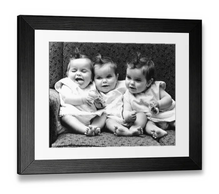 Framed Print : Three little girls sitting in an armchair