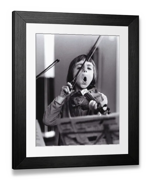 Framed Print : Child plays violin and sings, England