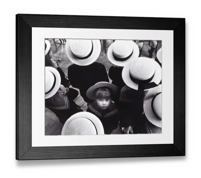 Framed Print : Little child looks up, standing between kids wearing straw hats