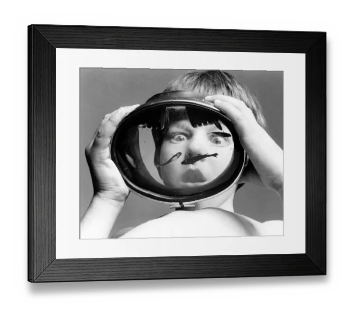 Framed Print : Child has small fish in his goggles