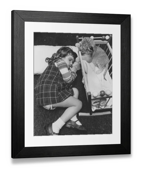 Framed Print : Girl sleeping next to a baby predator