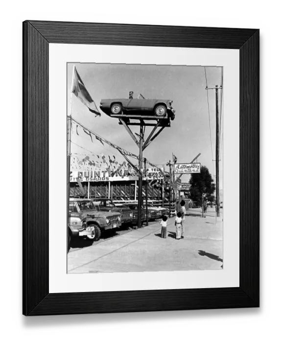 Framed Print : People gazing at car in the air Framed Print : People gazing at car in the air