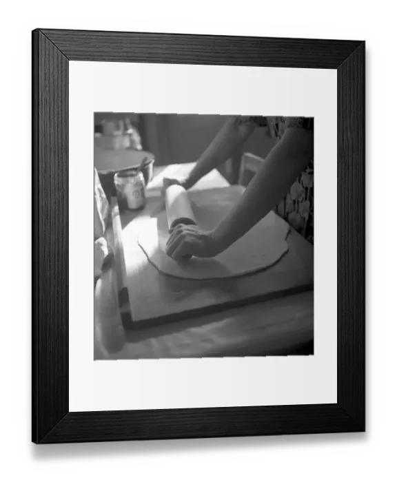 Framed Print : Woman rolls dough flat, housewife bakes Framed Print : Woman rolls dough flat, housewife bakes