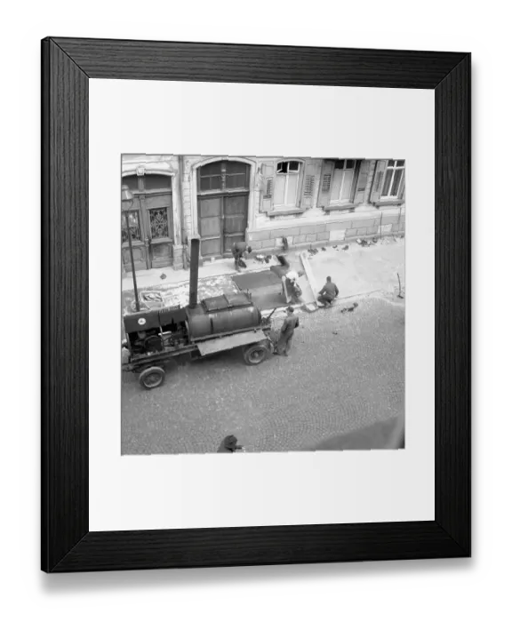 Framed Print : Construction workers repair and tar the pavement