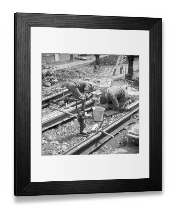 Framed Print : Construction workers laying tracks
