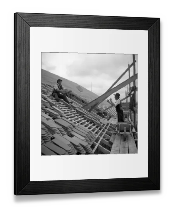 Framed Print : Two roofers throw themselves on a house tile to around 1950 Framed Print : Two roofers throw themselves on a house tile to around 1950