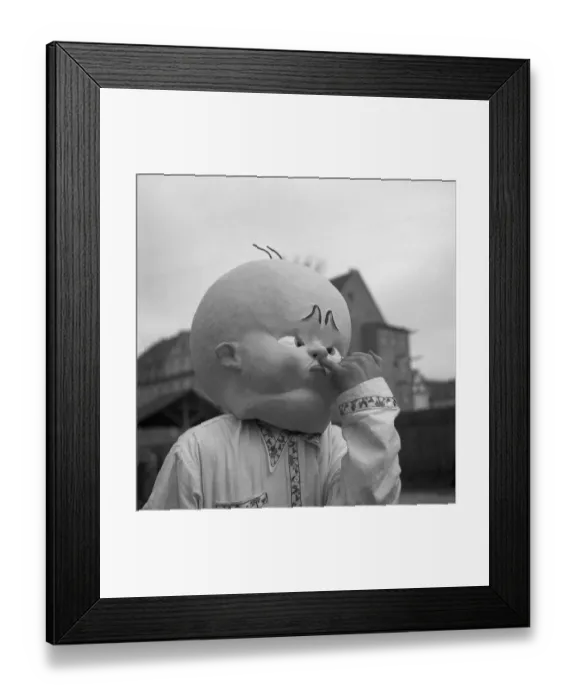 Framed Print : Man with huge baby mask, carnival Framed Print : Man with huge baby mask, carnival