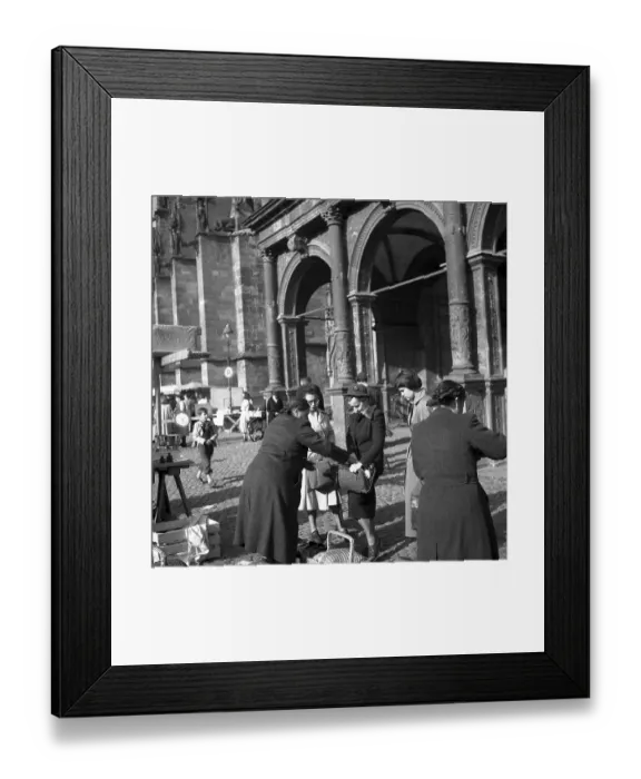 Framed Print : Seller puts something in the customer's pocket Framed Print : Seller puts something in the customer's pocket