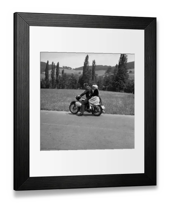 Framed Print : Man and daughter riding a motorbike on a country road Framed Print : Man and daughter riding a motorbike on a country road