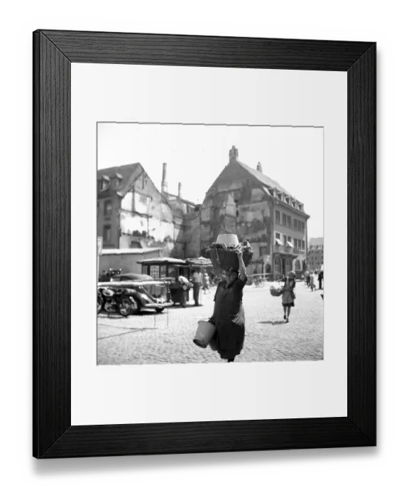 Framed Print : A woman carries a wooden basket on her head