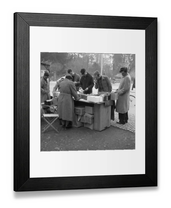 Framed Print : Men browse the books at a market stall