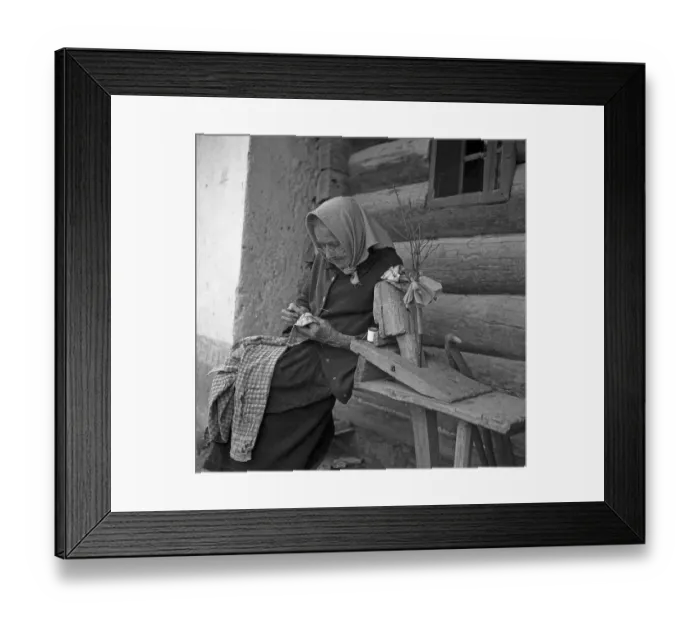 Framed Print : An elderly woman is sitting on a bench and knitting a shirt Framed Print : An elderly woman is sitting on a bench and knitting a shirt
