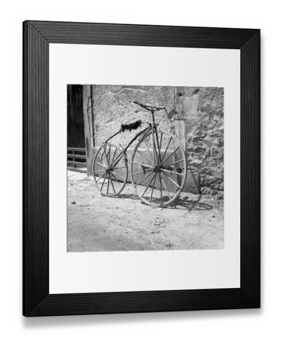 Framed Print : Pedal crank wheel leaning against a wall