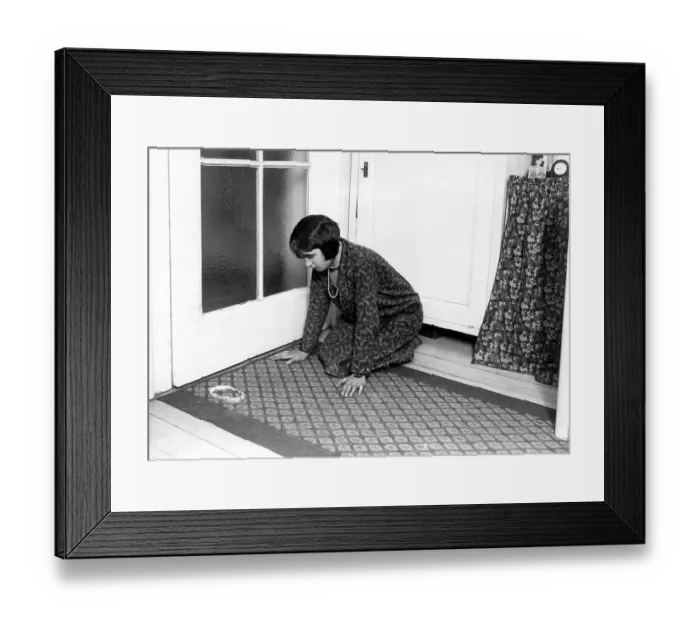 Framed Print : Woman kneels on the ground in front of an apple peel ca