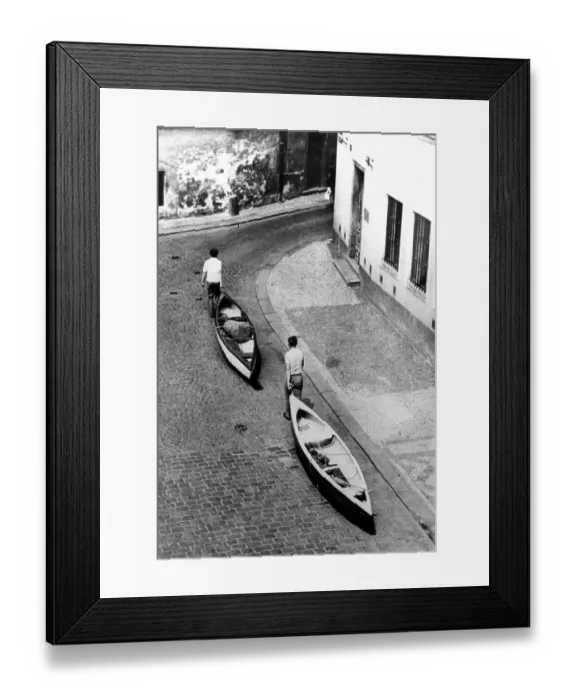 Framed Print : Men transport canoes, circa 1970s Framed Print : Men transport canoes, circa 1970s