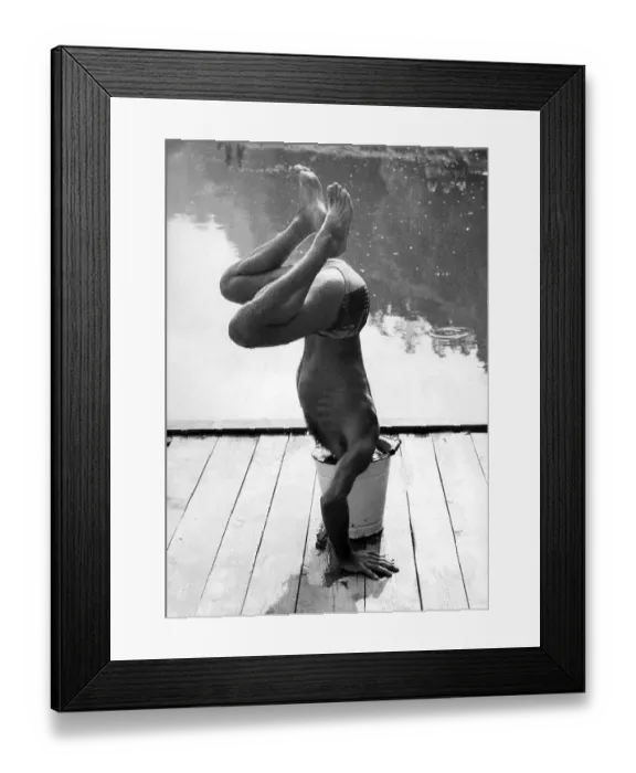 Framed Print : Man makes handstand and sticks head in bucket ca