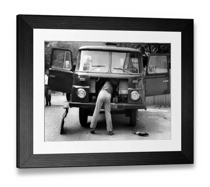 Framed Print : Man repairing trucks ca. 1970s