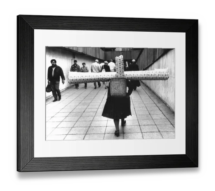 Framed Print : Woman carrying carpet about 1970s