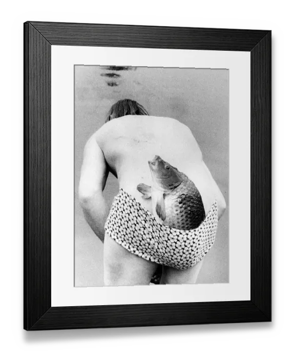 Framed Print : Man with fish in swimsuit ca. 1970s