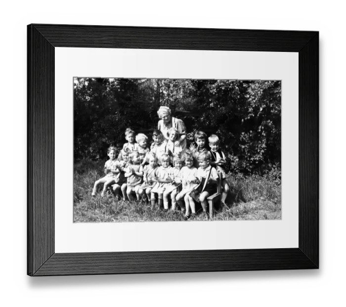 Framed Print : Children can be photographed in the green with the kindergarten teacher Framed Print : Children can be photographed in the green with the kindergarten teacher