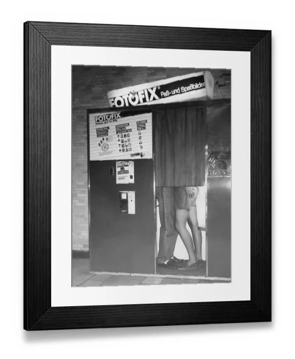 Framed Print : Flirting in a photo booth, ca. 1980s