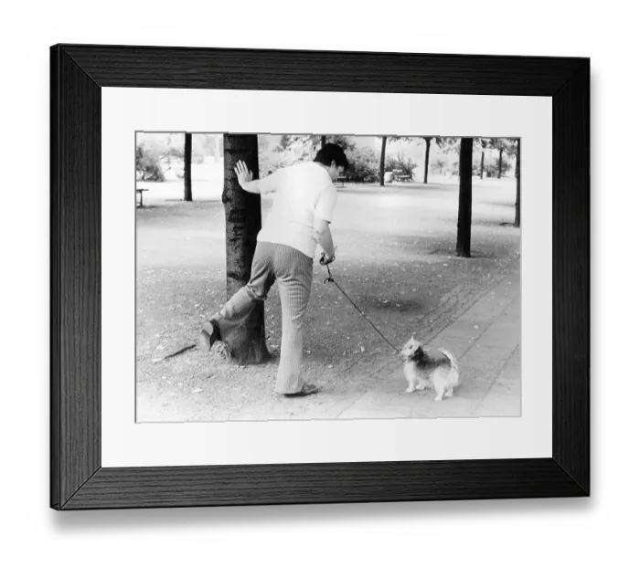 Framed Print : Woman showing a dog how to pee, ca