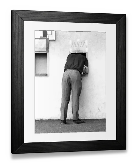 Framed Print : Man looking through a small window of a ticket sale Framed Print : Man looking through a small window of a ticket sale