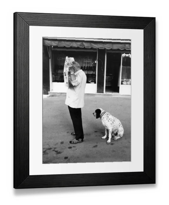 Framed Print : Dog waiting for reading man, between 50s and 60s