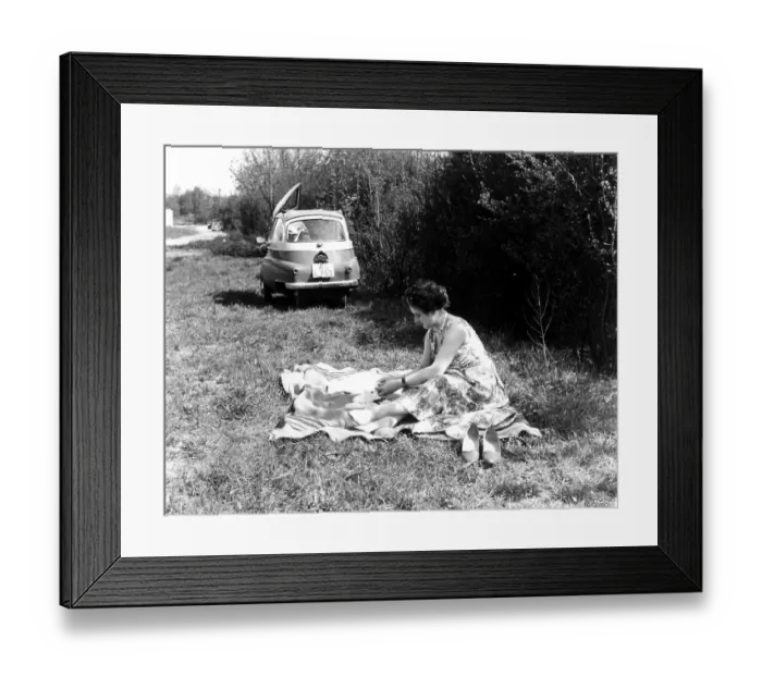 Framed Print : Woman making picnic, in the background an Isetta