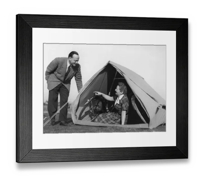Framed Print : Couple, camping, woman sitting in a tent with two bicycles Framed Print : Couple, camping, woman sitting in a tent with two bicycles