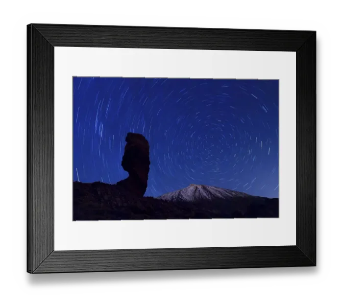 Framed Print : The Roque Cinchado at night with circling stars in the clear night sky and the summit of Pico de Teide