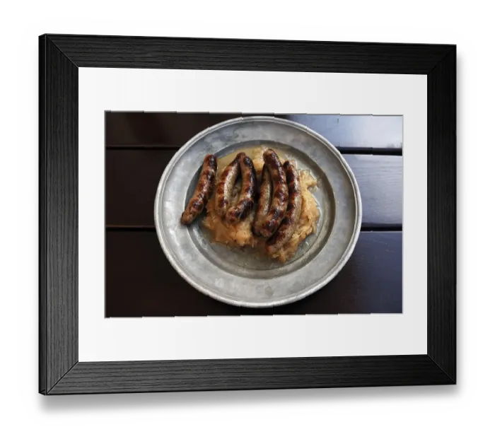 Framed Print : Six Nuremberg sausages with sauerkraut served on a pewter plate
