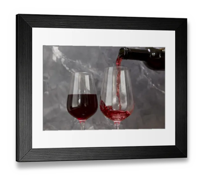 Framed Print : Wine bottle filling wineglass