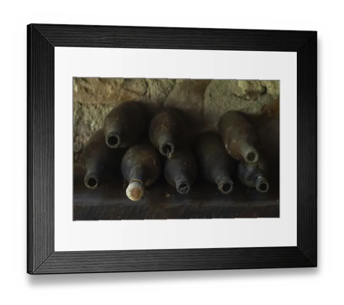 Framed Print : Old empty wine bottles standing abandoned on a shelf Framed Print : Old empty wine bottles standing abandoned on a shelf