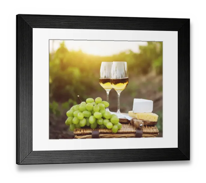Framed Print : Various sorts of cheese, grapes and two glasses of white wine in the vineyard